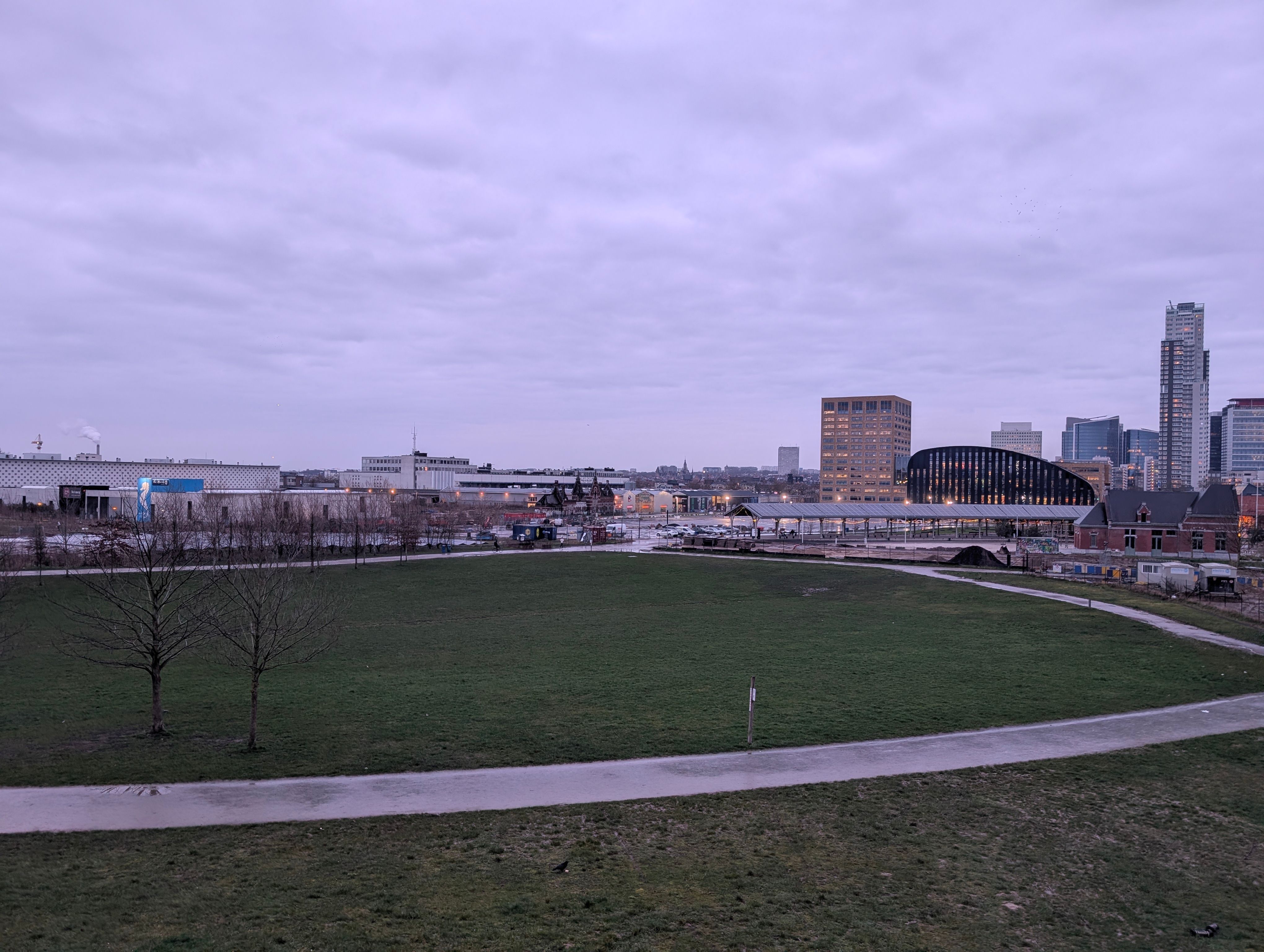 View near Tour & Taxis, Brussels 
green landscaping with buildings in the backdrop